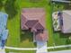 Aerial view of the home showcasing its roof, driveway, landscaping, and surrounding neighborhood at 12915 Carlington Ln, Riverview, FL 33579
