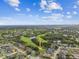 Stunning aerial view of a home overlooking a lush golf course and a picturesque community lake at 12915 Carlington Ln, Riverview, FL 33579