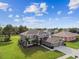 Aerial view of a two-story home with lush green lawn, mature trees and two car garage at 12915 Carlington Ln, Riverview, FL 33579