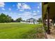 Large green backyard offers ample space for activities with a covered patio for shade and rest at 12915 Carlington Ln, Riverview, FL 33579
