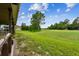 A green lawn stretches to the horizon by a covered patio, inviting relaxation and outdoor enjoyment at 12915 Carlington Ln, Riverview, FL 33579