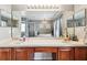 Bathroom featuring double sinks, large mirrors, and a separate tub and shower at 12915 Carlington Ln, Riverview, FL 33579