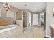 The bathroom features a soaking tub and separate shower with tile surround at 12915 Carlington Ln, Riverview, FL 33579