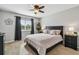 Cozy bedroom with a large window, black-out curtains and a comfortable bed at 12915 Carlington Ln, Riverview, FL 33579
