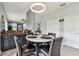 Cozy breakfast nook with leather chairs and a modern light fixture, adjacent to the kitchen at 12915 Carlington Ln, Riverview, FL 33579