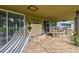 Inviting covered patio with a hammock, water feature, and outdoor dining area for comfortable living at 12915 Carlington Ln, Riverview, FL 33579