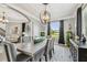 Elegant dining room with sophisticated lighting, neutral colors, and views to the outside, perfect for gatherings at 12915 Carlington Ln, Riverview, FL 33579