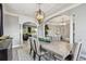 Elegant dining room featuring chandelier lighting, gray walls, and views into kitchen and living room at 12915 Carlington Ln, Riverview, FL 33579