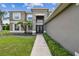 Inviting entryway featuring a manicured lawn and well-lit walkway leading to a modern front door at 12915 Carlington Ln, Riverview, FL 33579