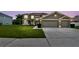 Beautiful home exterior with a well-manicured lawn, spacious driveway, and an attached two-car garage at 12915 Carlington Ln, Riverview, FL 33579