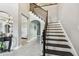 Welcoming foyer featuring stylish stairs, elegant decor, and an open floor plan at 12915 Carlington Ln, Riverview, FL 33579