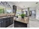 Contemporary kitchen features dark wood cabinets, granite countertops, and an open view of the back patio at 12915 Carlington Ln, Riverview, FL 33579