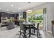 Modern kitchen features dark cabinetry, stainless steel appliances, a center island, and a cozy breakfast nook at 12915 Carlington Ln, Riverview, FL 33579
