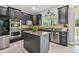 Well-equipped kitchen featuring stainless steel appliances, granite counters, and a functional center island at 12915 Carlington Ln, Riverview, FL 33579