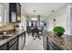 Modern kitchen featuring dark cabinets, and a view of the dining area with breakfast nook at 12915 Carlington Ln, Riverview, FL 33579