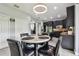 Open kitchen and dining area featuring black cabinetry, stainless appliances, and a light-filled breakfast nook at 12915 Carlington Ln, Riverview, FL 33579