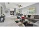 Inviting living room with an open layout, tile flooring, modern furniture, and easy access to the kitchen at 12915 Carlington Ln, Riverview, FL 33579
