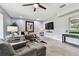 Open-concept living room with recessed lighting, stylish decor, comfortable seating, and a large flat-screen TV at 12915 Carlington Ln, Riverview, FL 33579
