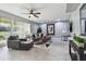 Spacious living room with tile flooring, neutral color scheme, modern furnishings, and ample natural light at 12915 Carlington Ln, Riverview, FL 33579