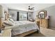This stunning main bedroom has a ceiling fan, and window with views at 12915 Carlington Ln, Riverview, FL 33579