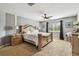 Bright main bedroom boasts a large bed, ceiling fan and window views at 12915 Carlington Ln, Riverview, FL 33579