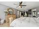 The light-filled main bedroom has a ceiling fan and easy access to other rooms at 12915 Carlington Ln, Riverview, FL 33579