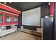 Home theater with a projector screen, comfortable seating, and movie posters for an immersive experience at 12915 Carlington Ln, Riverview, FL 33579