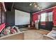 Cozy home theater with a large screen, comfortable seating, custom lighting, and a retro popcorn machine at 12915 Carlington Ln, Riverview, FL 33579
