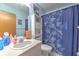 Bathroom with a vanity, toilet, and shower/tub combo with decorative curtain at 13311 Omega Ct, Dade City, FL 33525