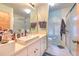 Bright bathroom featuring a modern vanity, tiled floor, and a glass-enclosed shower at 13311 Omega Ct, Dade City, FL 33525