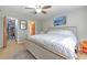 Comfortable bedroom with a ceiling fan, spacious closet, and stylish decor at 13311 Omega Ct, Dade City, FL 33525