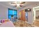 Bedroom featuring a ceiling fan, desk, and a cozy bed with colorful accents at 13311 Omega Ct, Dade City, FL 33525