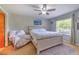 Cozy bedroom features a ceiling fan, large window, and comfortable seating area at 13311 Omega Ct, Dade City, FL 33525