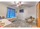 Cozy bedroom with a ceiling fan, playful decor, and a comfortable seating area at 13311 Omega Ct, Dade City, FL 33525