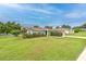 Lovely single-story home with manicured lawn and bushes creating a welcoming curb appeal at 13311 Omega Ct, Dade City, FL 33525