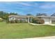 Charming single-story home featuring a well-maintained lawn and beautiful, mature landscaping at 13311 Omega Ct, Dade City, FL 33525