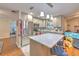 Well-equipped kitchen featuring stainless steel appliances, white cabinets, and a center island with bar seating at 13311 Omega Ct, Dade City, FL 33525