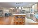Bright and open kitchen featuring white cabinets, stainless steel appliances, and a center island with bar seating at 13311 Omega Ct, Dade City, FL 33525