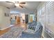 Bright and open living room with wood-look floors, stylish seating, and a view into the kitchen at 13311 Omega Ct, Dade City, FL 33525