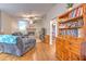 Cozy living room featuring a brick fireplace, plush seating, and a seamless transition to other living spaces at 13311 Omega Ct, Dade City, FL 33525