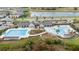 Aerial view of the community pool with lap lanes and splash area, featuring covered seating at 14672 Horse Trot Rd, Lithia, FL 33547