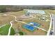 An aerial view of the playground, tennis courts, and walking paths by the pond in the community at 14672 Horse Trot Rd, Lithia, FL 33547