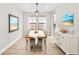 Well-lit dining room featuring a wooden table, modern chairs, and stylish decor at 14672 Horse Trot Rd, Lithia, FL 33547