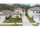 Charming two-story home featuring a two-car garage, manicured lawn and beautiful landscaping at 14672 Horse Trot Rd, Lithia, FL 33547