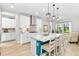 Modern kitchen with white cabinets, quartz countertops, stainless steel appliances, and a center island at 14672 Horse Trot Rd, Lithia, FL 33547