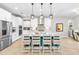 Modern kitchen featuring stainless steel appliances, white cabinets, and a center island with seating at 14672 Horse Trot Rd, Lithia, FL 33547