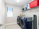 Well-lit laundry room with modern washer and dryer at 14672 Horse Trot Rd, Lithia, FL 33547