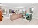 Spacious living area includes a large sofa, a wooden table and chairs, and plenty of natural light at 14672 Horse Trot Rd, Lithia, FL 33547
