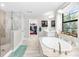 Luxurious bathroom with soaking tub, tiled shower, and views out of a garden window at 14672 Horse Trot Rd, Lithia, FL 33547