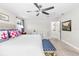 Bright bedroom offers a ceiling fan, natural light from a window, and an antique side table at 14672 Horse Trot Rd, Lithia, FL 33547